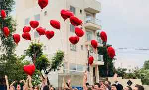 People releasing balloons.